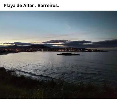 a large body of water with a city in the background at O xualtar Océano 2 in Villadaíde