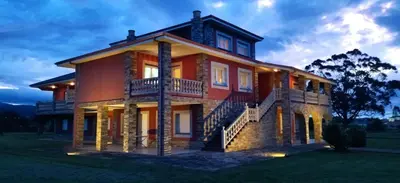 a large house with a balcony on top of it at Casa das Indias in Ribadeo