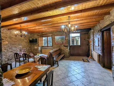 a dining room with a wooden ceiling and a table at O Val de Vilaboa in Bóveda