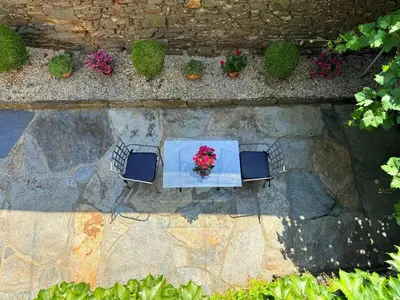 an overhead view of a table with two chairs and flowers at O Val de Vilaboa in Bóveda