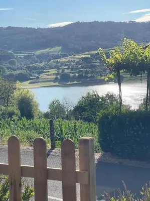 a fence in front of a river with a view at CASA DO XASTRE in Arnego