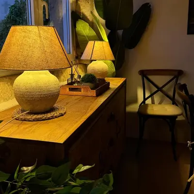 a table with a lamp and a chair on it at CASA DO XASTRE in Arnego