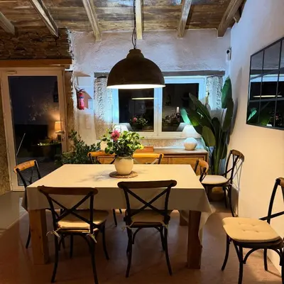 a dining room with a table and chairs at CASA DO XASTRE in Arnego