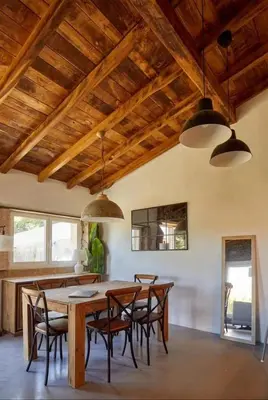 a dining room with a wooden table and chairs at CASA DO XASTRE in Arnego