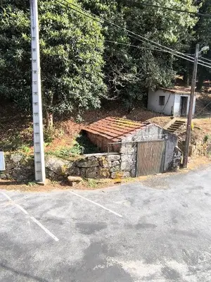 an empty parking lot next to a pole and a building at Casa o Pontillón in Rabiño