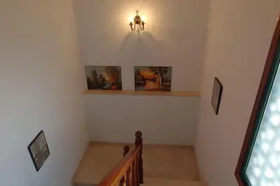 a staircase in a house with a light on the wall at Casa o Pontillón in Rabiño