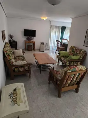 a living room with couches and a table and a tv at Casa o Pontillón in Rabiño