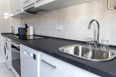 a kitchen with a sink and a counter top at Piso Turístico Las Nisas I in Puerto de Vega