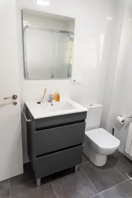 a bathroom with a sink and a toilet at Piso Turístico Las Nisas I in Puerto de Vega