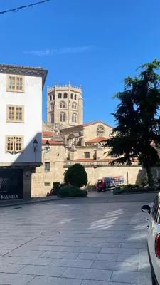 a large building with a clock tower in the background at Apartamento Ainaran Confortable apartamento en el centro de Orense in Ourense