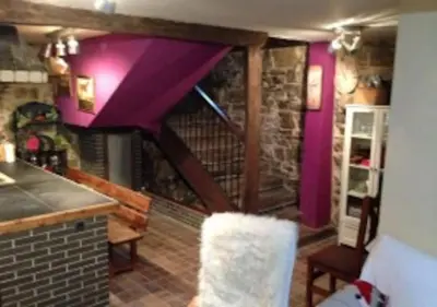 a kitchen with purple walls and a purple ceiling at O Recuncho de Doiras in Ferreiravedés