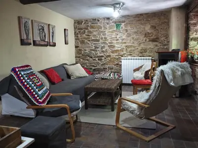 a living room with a couch and two chairs at O Recuncho de Doiras in Ferreiravedés