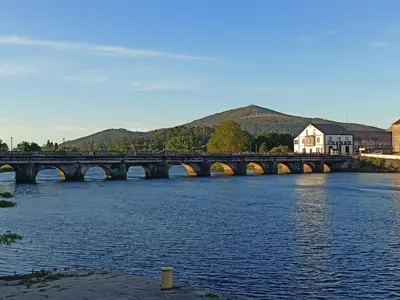 a bridge over a river with a train on it at Cesuresrooms2 in Puentecesures