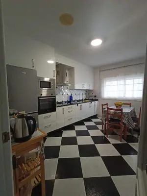 a kitchen with a black and white checkered floor at Cesuresrooms2 in Puentecesures