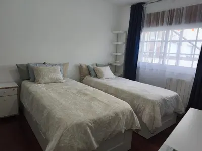 a bedroom with two beds next to a window at Cesuresrooms2 in Puentecesures