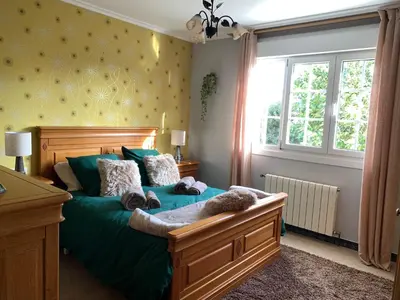 a dog laying on a bed in a bedroom at Casa Quercus Galicia a 17 minutos de Compostela! in A Estrada