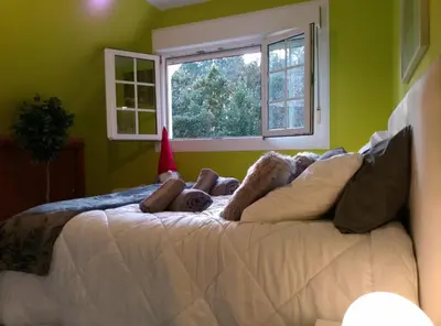 a bedroom with two bunk beds and a window at Casa Quercus Galicia a 17 minutos de Compostela! in A Estrada
