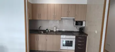 a small kitchen with a sink and a microwave at Mariña in Viveiro