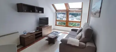 a living room with a couch and a tv at Mariña in Viveiro