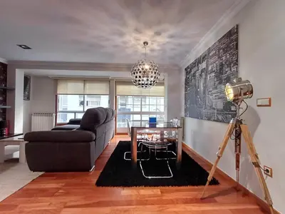 a living room with a couch and a table at Bedoya - Amplio y moderno piso en pleno centro de Ourense in Ourense