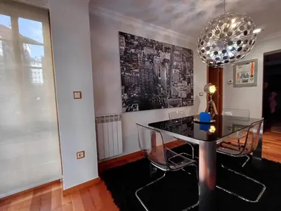 a dining room with a glass table and a chandelier at Bedoya - Amplio y moderno piso en pleno centro de Ourense in Ourense