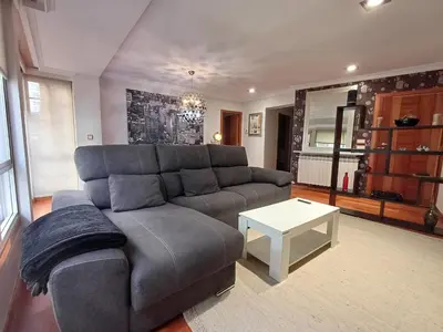a living room with a couch and a table at Bedoya - Amplio y moderno piso en pleno centro de Ourense in Ourense