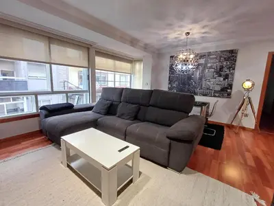 a living room with a couch and a table at Bedoya - Amplio y moderno piso en pleno centro de Ourense in Ourense