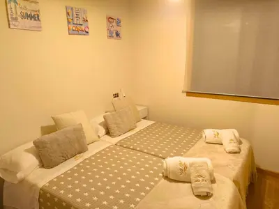 a bedroom with two beds with towels on them at Costa SPA Ático de lujo - Playa de las Catedrales in San Miguel de Reinante