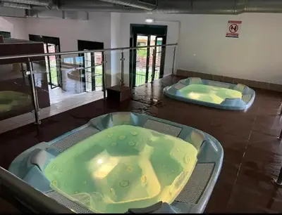 a large jacuzzi tub in a room with two trays at Costa SPA Ático de lujo - Playa de las Catedrales in San Miguel de Reinante