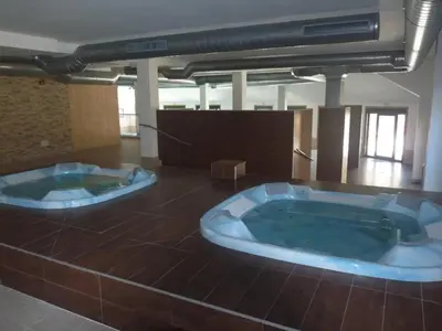 two large jacuzzi tubs in a room at Costa SPA Ático de lujo - Playa de las Catedrales in San Miguel de Reinante
