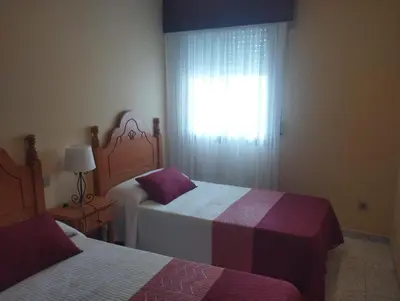 a bedroom with two beds and a window at Vivienda PLAYA DE ALTAR in Barreiros
