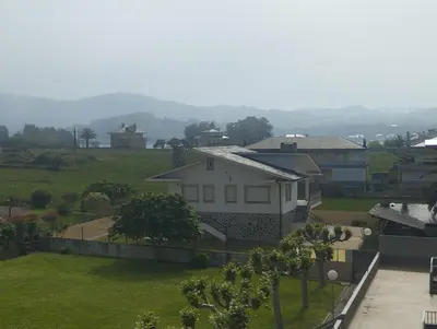 a view of a house with a green yard at Vivienda PLAYA DE ALTAR in Barreiros