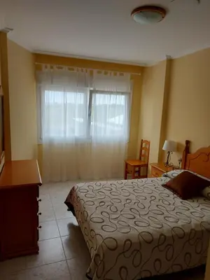 a bedroom with a bed and a window at Vivienda PLAYA DE ALTAR in Barreiros