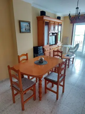 a living room with a wooden table and chairs at Vivienda PLAYA DE ALTAR in Barreiros