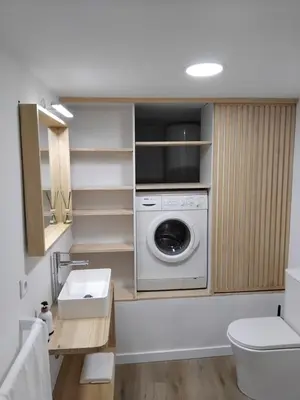 a bathroom with a washing machine and a sink at Sita in A Estrada