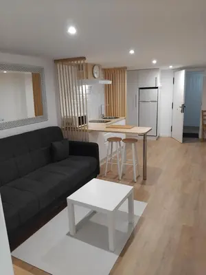 a living room with a black couch and a table at Sita in A Estrada