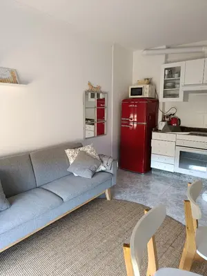 a living room with a couch and a red refrigerator at Bahía de Miño in Miño