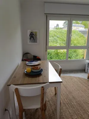a table and chairs with a plate of food on it at Bahía de Miño in Miño