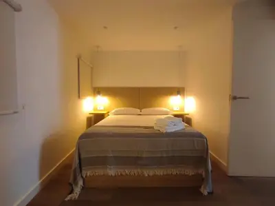 a bedroom with a bed with two lights on it at Lepanto2 - En el centro gastronómico y junto a la catedral in Ourense