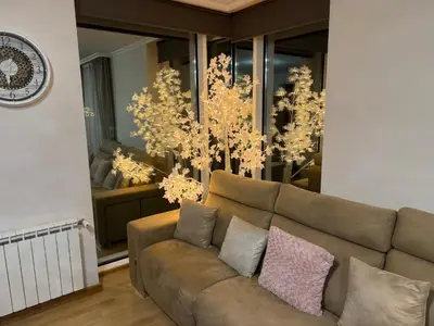 a living room with a couch and chandeliers at Maison Liberdade By Oktheway in Sarria