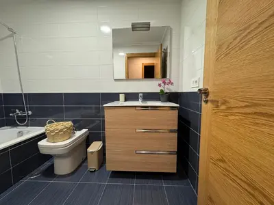 a bathroom with a toilet and a sink and a mirror at Maison Liberdade By Oktheway in Sarria