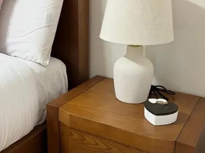 a white lamp on a wooden table next to a bed at Maison Liberdade By Oktheway in Sarria