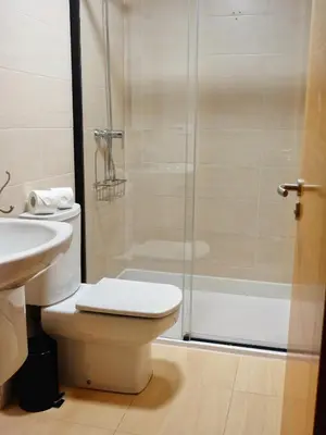 a bathroom with a shower and a toilet and a sink at Atalaia Apartment Foz in Foz