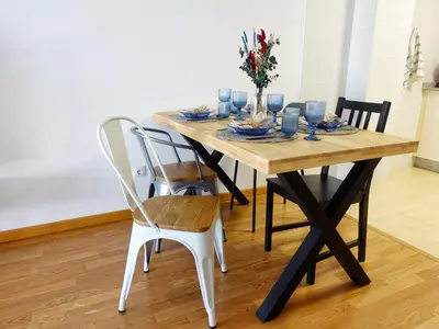 a dining room table with white chairs and a wooden table at Atalaia Apartment Foz in Foz
