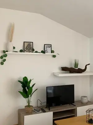a living room with a flat screen tv on a wall at Rincón de Noa in Melide