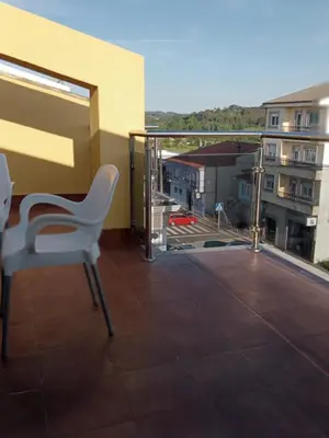a white chair sitting on top of a balcony at Rincón de Noa in Melide