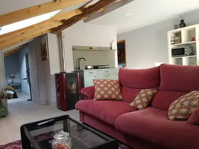 a living room with a red couch and a table at Apartamento Riazón3 in Ourense
