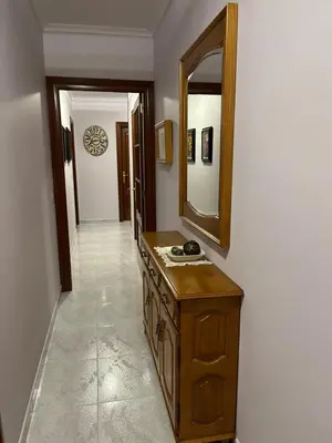 a bathroom with a wooden vanity and a mirror at O Carballal in A Pontenova