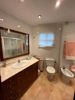 a bathroom with a sink and a toilet and a mirror at O Carballal in A Pontenova