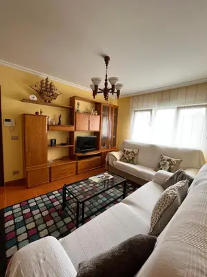 a living room with two couches and a tv at O Carballal in A Pontenova